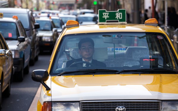Taxi driver sitting in traffic on Sony street in Ginza area.